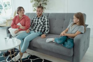 A family therapy session with parents and child discussing emotions with a psychologist in Scottsdale, AZ.
